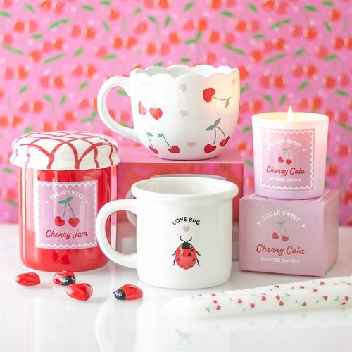 Collection of Love Bug mug, candles, and Cherry mug – unique gifts for all occasions, featuring whimsical designs and thoughtfu4l details.