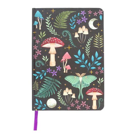 A5 notebook featuring a dark forest design with mystical mushrooms, a glowing luna moth, and magickal plants, accented by gold foil edges and a ribbon marker.