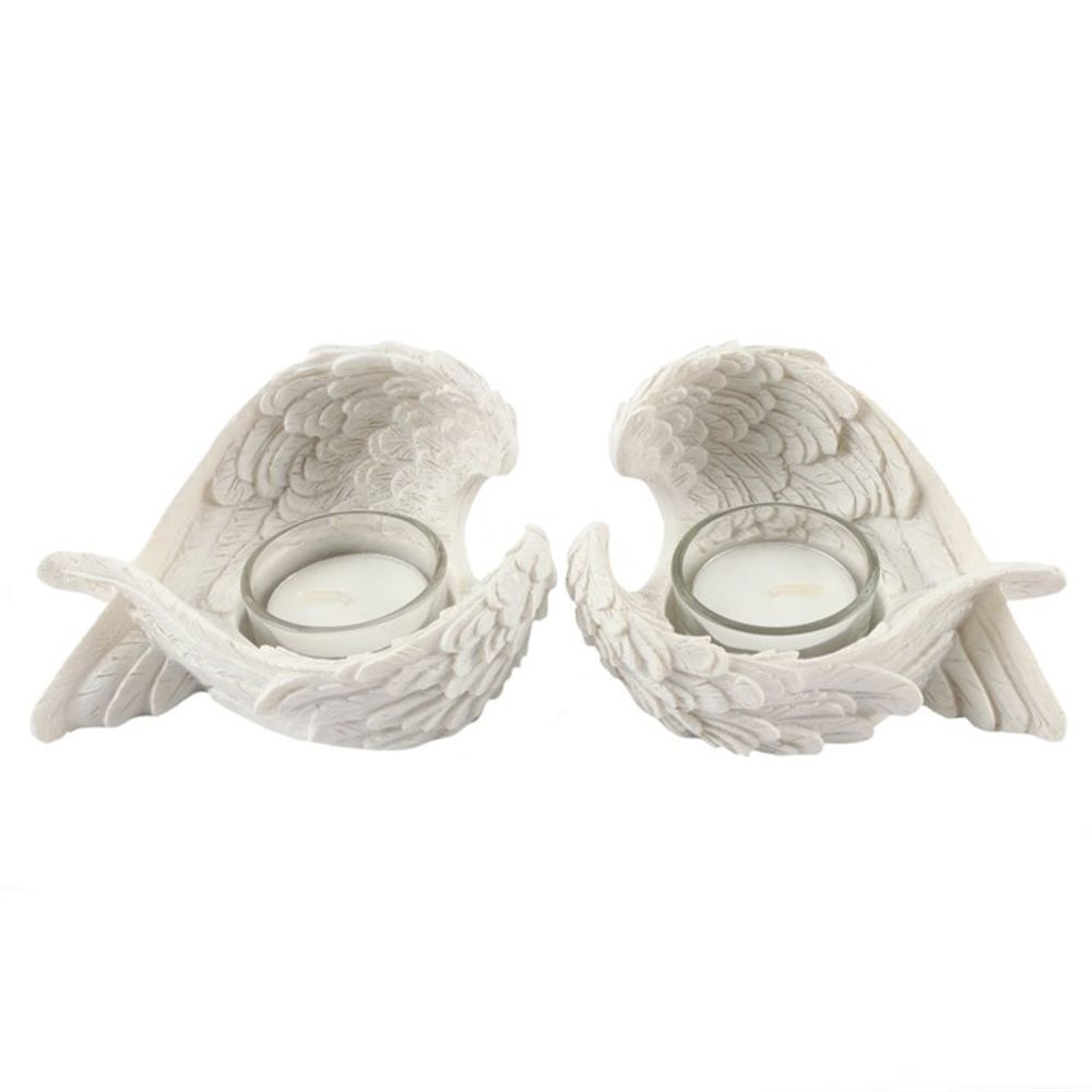 Set of 2 white resin angel wing tealight holders, perfect for creating a serene and elegant ambiance on a mantle or tabletop.