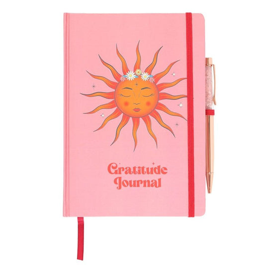 The Sun Gratitude Journal featuring vibrant sun-themed artwork on the cover, accompanied by a luxurious rose quartz pen, designed for daily reflection and gratitude.