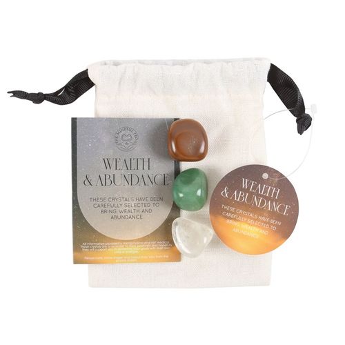 Wealth and Abundance Manifestation Kit with crystals, candles, and storage bag. Perfect for attracting prosperity and success.