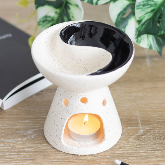 Yin yang oil burner and wax warmer with split dish for mixing essential oils or wax melts, ideal for creating a relaxing and balanced atmosphere.

